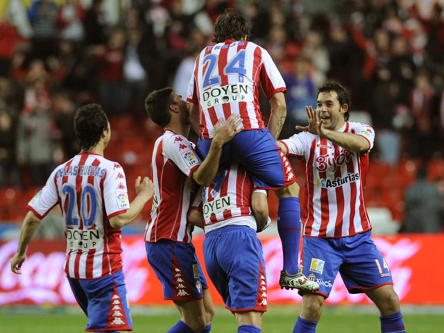 Sporting Gijon's players celebrate their